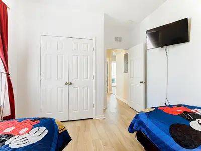 a bedroom with a bed and a flat screen tv at Two Miles Disney Pool Water Park & Water slide in Orlando