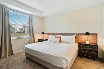 a bedroom with a large bed and a window at 3120 Paradox Circle 104 in Kissimmee