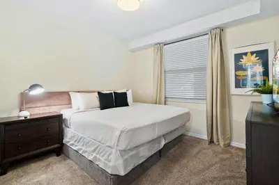 a bedroom with a large bed and a window at 3120 Paradox Circle 104 in Kissimmee