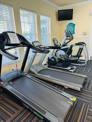 a gym with two treadmills and a treadmill at 4 bed Single Level Home in Windsor Palms Sleeps 8 in Kissimmee