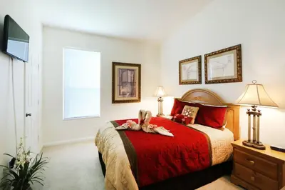 a bedroom with a bed with two animals on it at 4 bed Single Level Home in Windsor Palms Sleeps 8 in Kissimmee