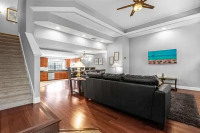 a living room with a couch and a ceiling fan at Sunny Summer in FL - Relax in a TownHome by Disney! in Orlando