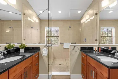a bathroom with two sinks and a shower at Sunny Summer in FL - Relax in a TownHome by Disney! in Orlando