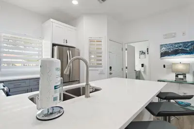 a kitchen with white cabinets and a sink at Allure - Sleeps 8 - 3 BDM - Disney in Kissimmee