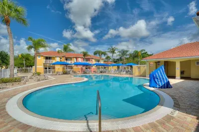 a swimming pool at a resort with palm trees at Allure - Sleeps 8 - 3 BDM - Disney in Kissimmee