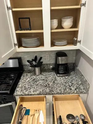 a kitchen with a counter top with plates and a coffee maker at 4br Disney Retreat Gated Resort with Pool & Hot Tub in Orlando