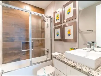 a bathroom with a white sink and a shower at 4br Disney Retreat Gated Resort with Pool & Hot Tub in Orlando
