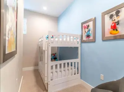 a white crib in a childs room at 4br Disney Retreat Gated Resort with Pool & Hot Tub in Orlando