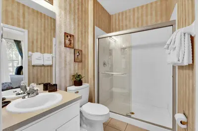 a bathroom with a shower and a toilet and a sink at The Sunny Nest in Orlando