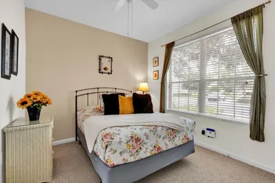a bedroom with a bed and a window at The Sunny Nest in Orlando