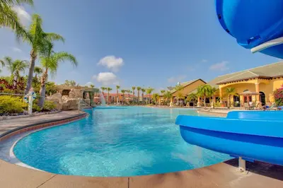 a large swimming pool at a resort with palm trees at 8953 Candy Palm Road in Kissimmee