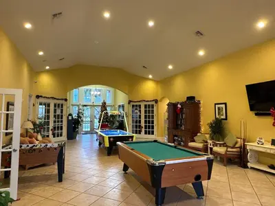 a living room with a pool table in it at Casa 4 Quartos - 20min Disney - Seven Dwarfs in Kissimmee