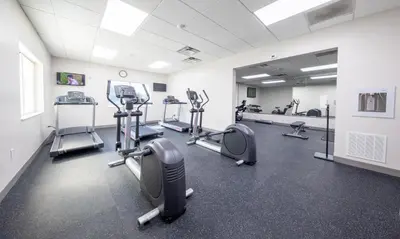 a gym with treadmills and ellipticals in a room at Holiday Inn Express & Suites Clermont SE - West Orlando by IHG in Orlando