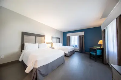 a hotel room with two beds and a desk at Holiday Inn Express & Suites Clermont SE - West Orlando by IHG in Orlando