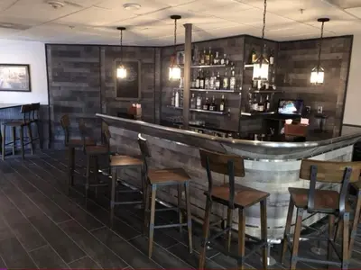a bar with wooden stools in a restaurant at 6165 Carrier Drive Unit 1802 Building 1 in Orlando