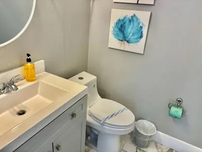 a bathroom with a white toilet and a sink at 6165 Carrier Drive Unit 1802 Building 1 in Orlando