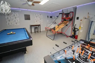a living room with a pool table and a billiards at Gorgeous 4 Bed Home In Gated Community in Kissimmee