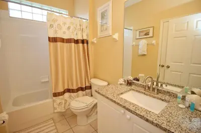 a bathroom with a sink and a toilet and a shower at Luxury Villa Private Pool And Great Game Room in Kissimmee