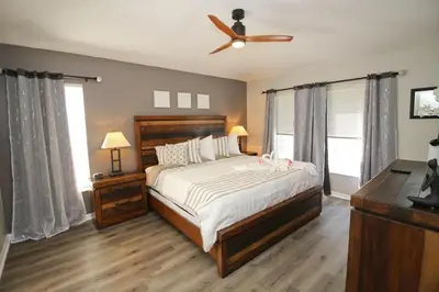 a bedroom with a bed and a ceiling fan at Newly Renovated Home With Calming Atmosphere in Kissimmee