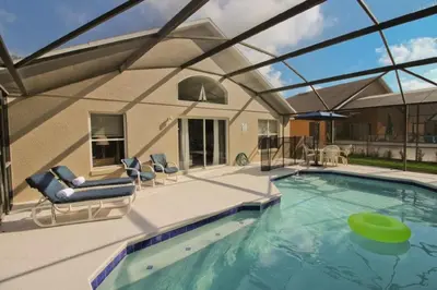 a swimming pool with a green frisbee in the water at Newly Renovated Home With Calming Atmosphere in Kissimmee