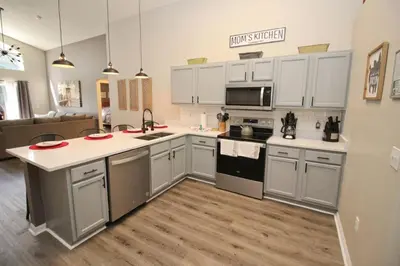 a kitchen with white cabinets and a counter top at Newly Renovated Home With Calming Atmosphere in Kissimmee