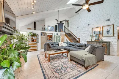 a living room with a couch and a table at 10 Mi to Disney World Lakeside Orlando Getaway! in Orlando