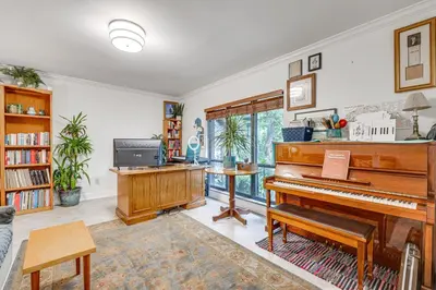 a living room with a piano and a desk at 10 Mi to Disney World Lakeside Orlando Getaway! in Orlando