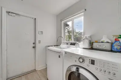 a laundry room with a washing machine and a window at 10 Mi to Disney World Lakeside Orlando Getaway! in Orlando