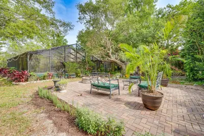 a patio with benches and plants in a garden at 10 Mi to Disney World Lakeside Orlando Getaway! in Orlando