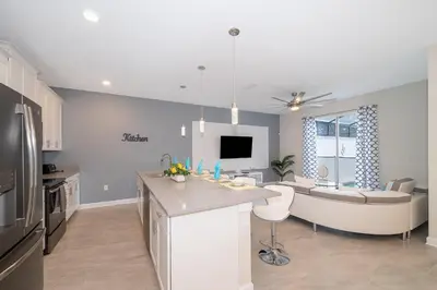a kitchen and living room with a tub and a couch at 5011CL TOWNHOME 4 BEDS 3 BATHS FREE WATERPARK in Kissimmee