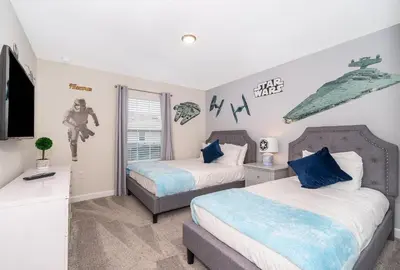 a bedroom with two beds and a tv in it at 4816LN TOWNHOUSE 4 BEDROOMS 3 BATHROOMS PRIVATE POOL in Kissimmee