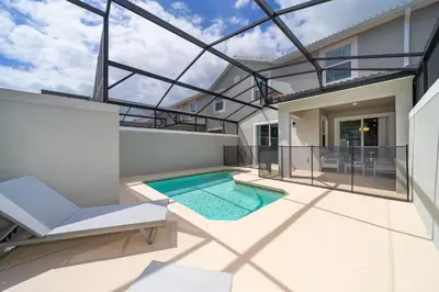 a view of a house with a swimming pool at 4816LN TOWNHOUSE 4 BEDROOMS 3 BATHROOMS PRIVATE POOL in Kissimmee