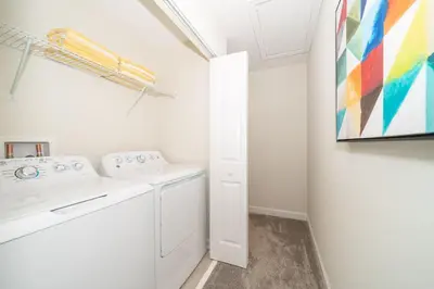 a white laundry room with a washer and dryer at 4816LN TOWNHOUSE 4 BEDROOMS 3 BATHROOMS PRIVATE POOL in Kissimmee