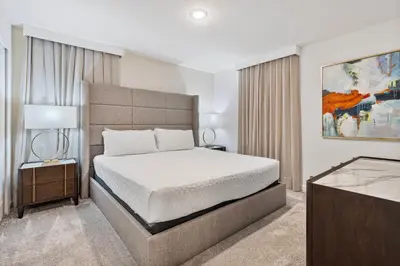 a bedroom with a large bed and a table at New Home 9 Bedrooms and 5 Bathrooms At Storey Lake in Kissimmee
