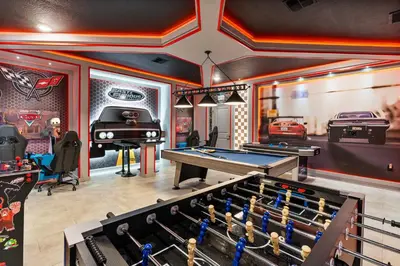 a room with a pool table and a garage at New Home 9 Bedrooms and 5 Bathrooms At Storey Lake in Kissimmee