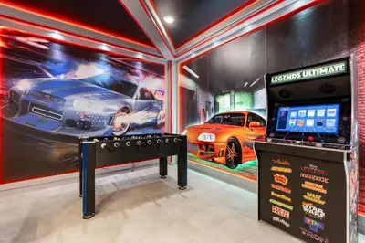 a video game room with a racing car on the wall at New Home 9 Bedrooms and 5 Bathrooms At Storey Lake in Kissimmee