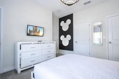 a white bedroom with a white bed and a dresser at Gorgeous 4Bd with Pool and Waterpark at Storey Lake 4836M in Kissimmee