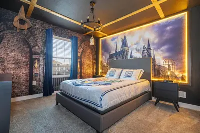 a bedroom with a king sized bed with a poster on the wall at Gorgeous 4Bd with Pool and Waterpark at Storey Lake 4836M in Kissimmee