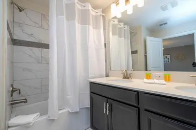 a bathroom with two sinks and a shower at Gorgeous 4Bd with Pool and Waterpark at Storey Lake 4836M in Kissimmee