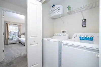 a white laundry room with a washer and dryer at Gorgeous 4Bd with Pool and Waterpark at Storey Lake 4836M in Kissimmee