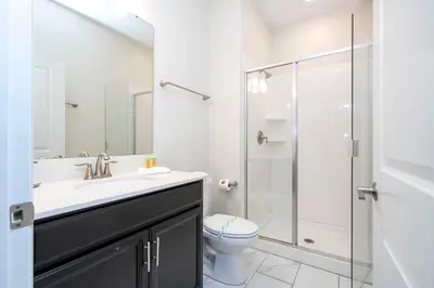 a bathroom with a sink and a toilet and a shower at Gorgeous 4Bd with Pool and Waterpark at Storey Lake 4836M in Kissimmee