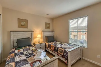 a bedroom with two beds and a window at 2711 - Jungle Book Bungalow - DO NOT DO in Orlando