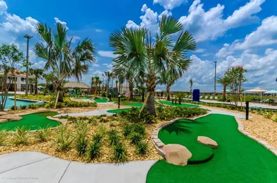 a golf course at the resort with palm trees at 3120 Paradox Circle 301 in Kissimmee