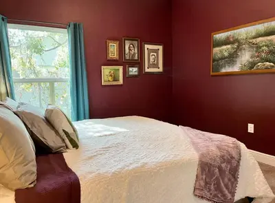 a bedroom with a white bed with a window at Sweet Stay with fully fenced yard in Sanford