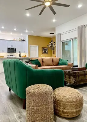 a living room with a green couch and a table at Sanford's Seahaven in Sanford