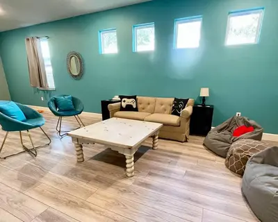 a living room with a couch and a table at The Arcade close to downtown with fenced yard in Sanford