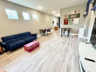a living room with a blue couch and a table at The Billiard close to downtown with fenced yard in Sanford