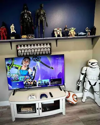a living room with a tv and a shelf with toys at The Billiard close to downtown with fenced yard in Sanford