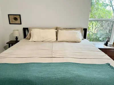 a large bed in a bedroom with a large window at The Butterfly House - with sauna in Sanford