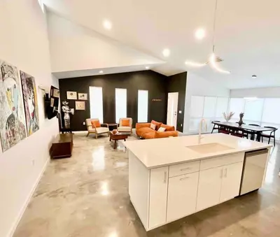 a kitchen and living room with a couch and a table at The Butterfly House - with sauna in Sanford